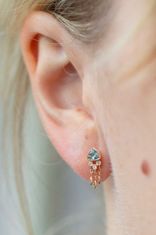 model wearing Triangle Aquamarine & Diamond Single Earring 14k light yellow gold earring
One dark blue aquamarine
Diamonds and dangling details