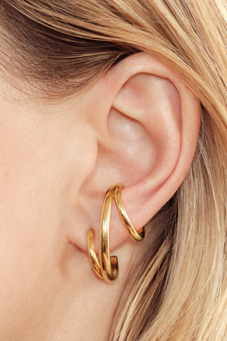 model wearing Triplet Single Earring - Left Vermeil Sold as a single "left" earring
Only for pierced ears
Yellow vermeil 18 karats and 925 Rhodium Plated Sterling Silver
