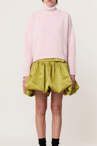 front profile model wearing  Turtleneck Sweater pink Pastel pink turtleneck sweater
Wool-cashmere blend
Relaxed fit
Dropped shoulders
Ribbed detailing on the collar, cuffs, and hem
70% Wool knit 30% Cashmere knit