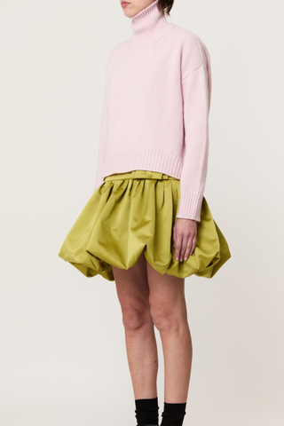 side profile model wearing  Turtleneck Sweater pink Pastel pink turtleneck sweater
Wool-cashmere blend
Relaxed fit
Dropped shoulders
Ribbed detailing on the collar, cuffs, and hem
70% Wool knit 30% Cashmere knit