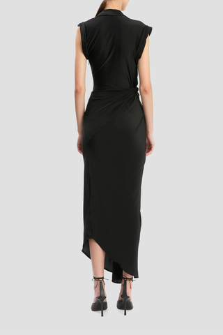 back profile model wearing  Twist Detail CDC Dress Black Asymmetric, drape midi dress
High shine jersey bodice
Crepe de chine skirt
Wrap front neckline with button &amp; thread loop closure
Short roll sleeve
Twist drape waist detail
Front skirt split
Concealed side zip