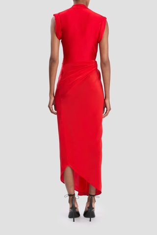 back profile model wearing Twist Detail CDC Dress Red Asymmetric, drape midi dress
High shine jersey bodice
Crepe de chine skirt
Wrap front neckline with button &amp; thread loop closure
Short roll sleeve
Twist drape waist detail
Front skirt split
Concealed side zip