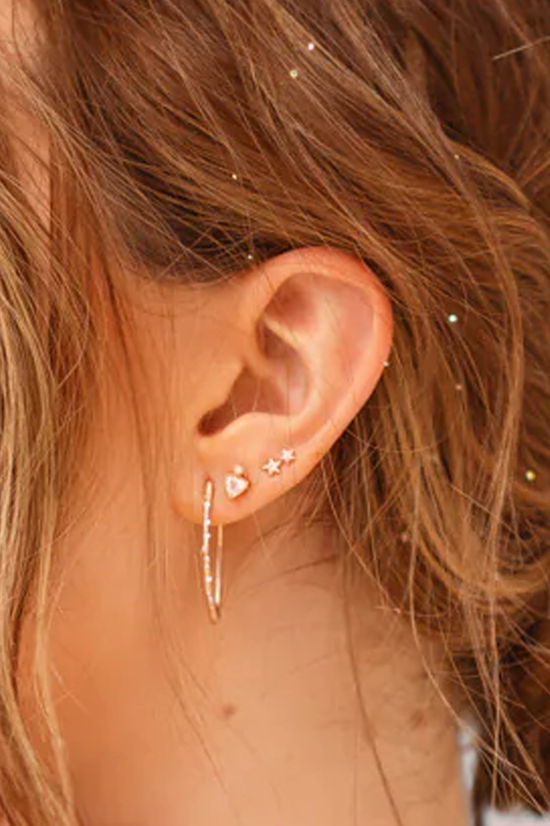 model wearing Two Twinkling Star Earring 14k gold