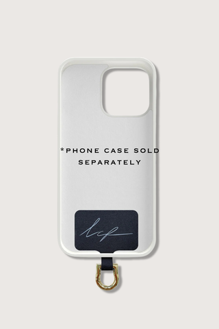 flat lay of Universal Adapter Made of fabric with a stainless steel coating gold with example phone case