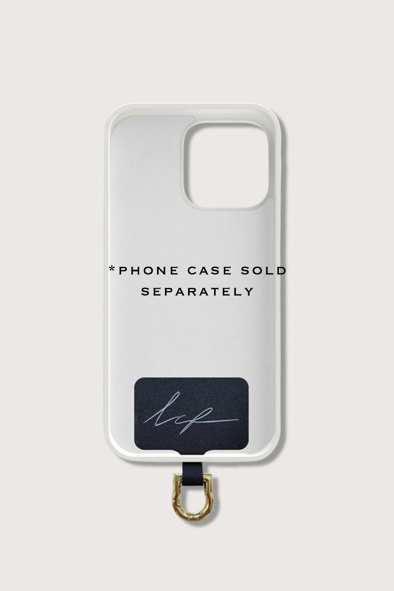 flat lay of Universal Adapter Made of fabric with a stainless steel coating gold with example phone case