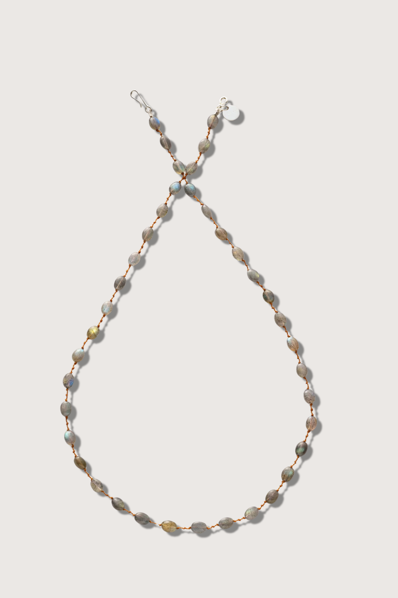 flat lay Valley Labradorite Necklace The stones, subtly spaced by three delicate knots Harmoniously follow one another on a silky cord 14k gold-filled clasp