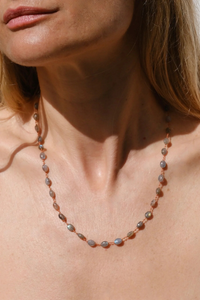 model wearing Valley Labradorite Necklace The stones, subtly spaced by three delicate knots Harmoniously follow one another on a silky cord 14k gold-filled clasp
