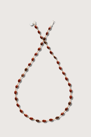 flat lay Valley Red Jasper Necklace The stones, subtly spaced by three delicate knots Harmoniously follow one another on a silky cord 14k gold-filled clasp