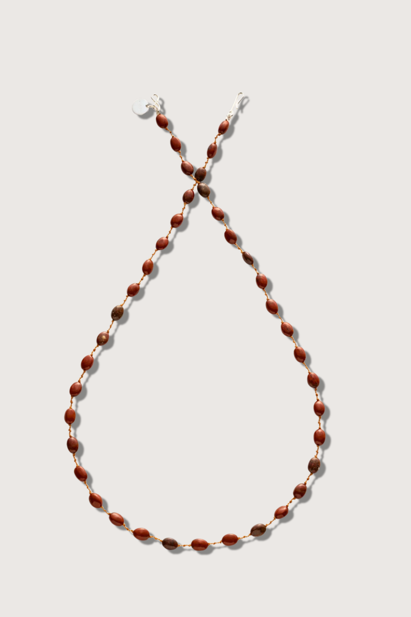 flat lay Valley Red Jasper Necklace The stones, subtly spaced by three delicate knots Harmoniously follow one another on a silky cord 14k gold-filled clasp