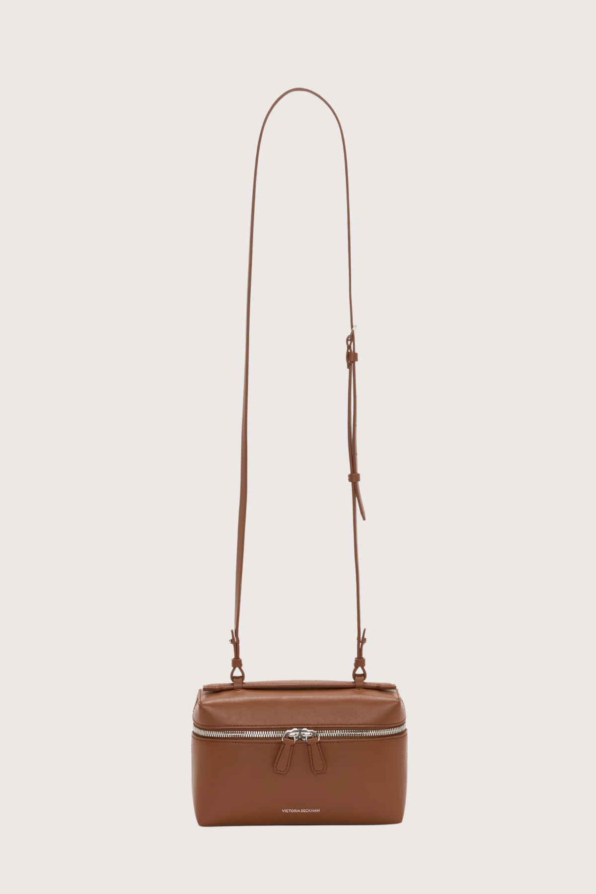 front profile Vanity Crossbody Bag tan 
Top handle
Removable crossbody strap
Microsuede lining
Top handle functionality
Zip closure
100% Calf Leather