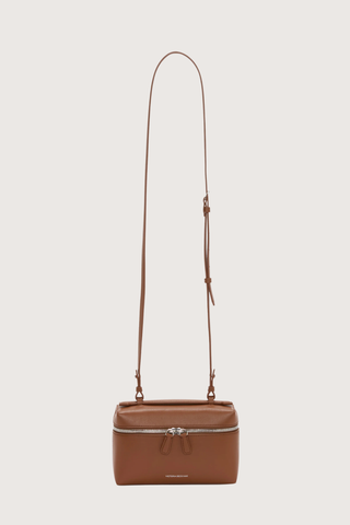 front profile Vanity Crossbody Bag tan 
Top handle
Removable crossbody strap
Microsuede lining
Top handle functionality
Zip closure
100% Calf Leather