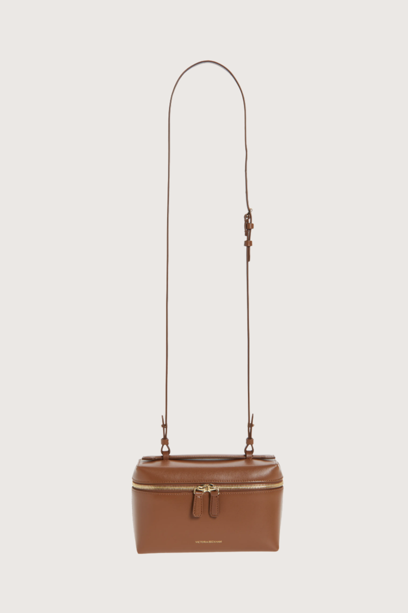 front profile Vanity Crossbody Bag tan 
Top handle
Removable crossbody strap
Microsuede lining
Top handle functionality
Zip closure
100% Calf Leather