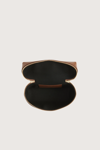 inside view of Vanity Crossbody Bag tan 
Top handle
Removable crossbody strap
Microsuede lining
Top handle functionality
Zip closure
100% Calf Leather