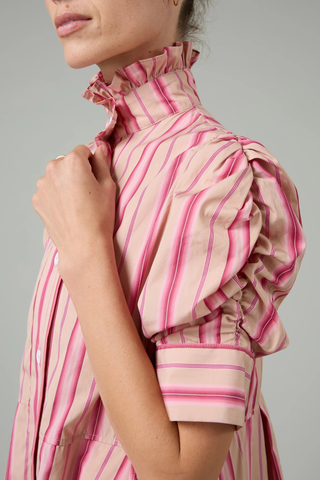 close up sleeve and collar detail for Venetia Stripe Short Sleeve Dress  biscuit pink stripe High neck with ruffle trim
Button front closure
Puff sleeves
Ruched sleeve with thick cuffs
Midi length
Vertical stripes
100% Cotton