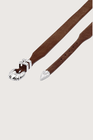 angled view Versailles Brown Suede Belt Hand-worked tapered silhouette, gradually shifting from 3.6 cm to 2 cm
4-piece “Versailles” buckle in an antique silver finish
100% suede
Solid brass hardware
Buckle: 2 cm
Height: 3.6 cm to 2 cm