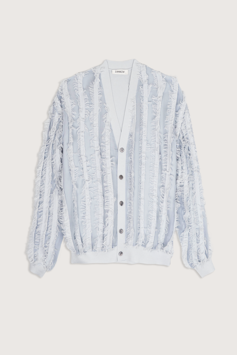 flat lay Wes Merino Wool Fringe Cardigan oyster light blue
V-neck
Fringe throughout front and sleeve
No fringe on the back
Button front
Relaxed fit