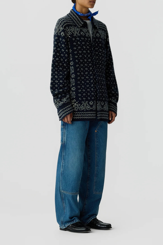 side profile model wearing Wild Rag Work overshirt Midnight blue Unisex 
Knit from mid-weight 100% cashmere
Relaxed fit
Classic shirt collar
Bandana print throughout
Chest patch pocket
Front button down closure
Button sleeve cuff with placket