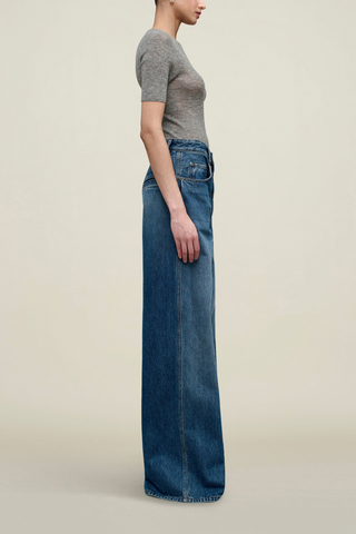 side profile model wearing Winona Wide Leg Jean Americana blue wash Extra wide leg, Fitted waist, relaxed fit, long rise, puddling bottom look