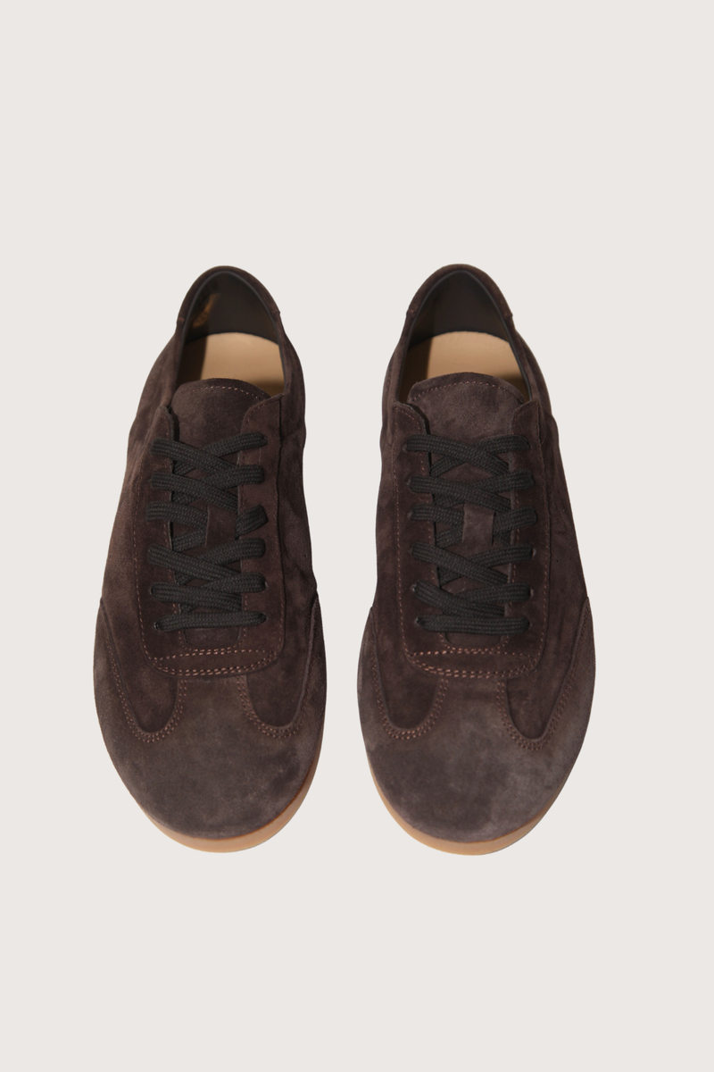 front profile model wearing Winter Driving Sole Sneaker in Suede mocha brown Upper: Suede
Lining: Leather
Lace-up closure
Round toe
Rubber thin sole