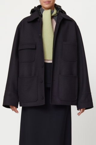 front profile model wearing Wool Hooded Jacket black Double wool cargo jacket, Four front pockets, Covered buttons, Detachable black shiny hood