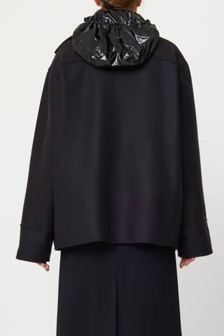 back profile model wearing Wool Hooded Jacket black Double wool cargo jacket, Four front pockets, Covered buttons, Detachable black shiny hood