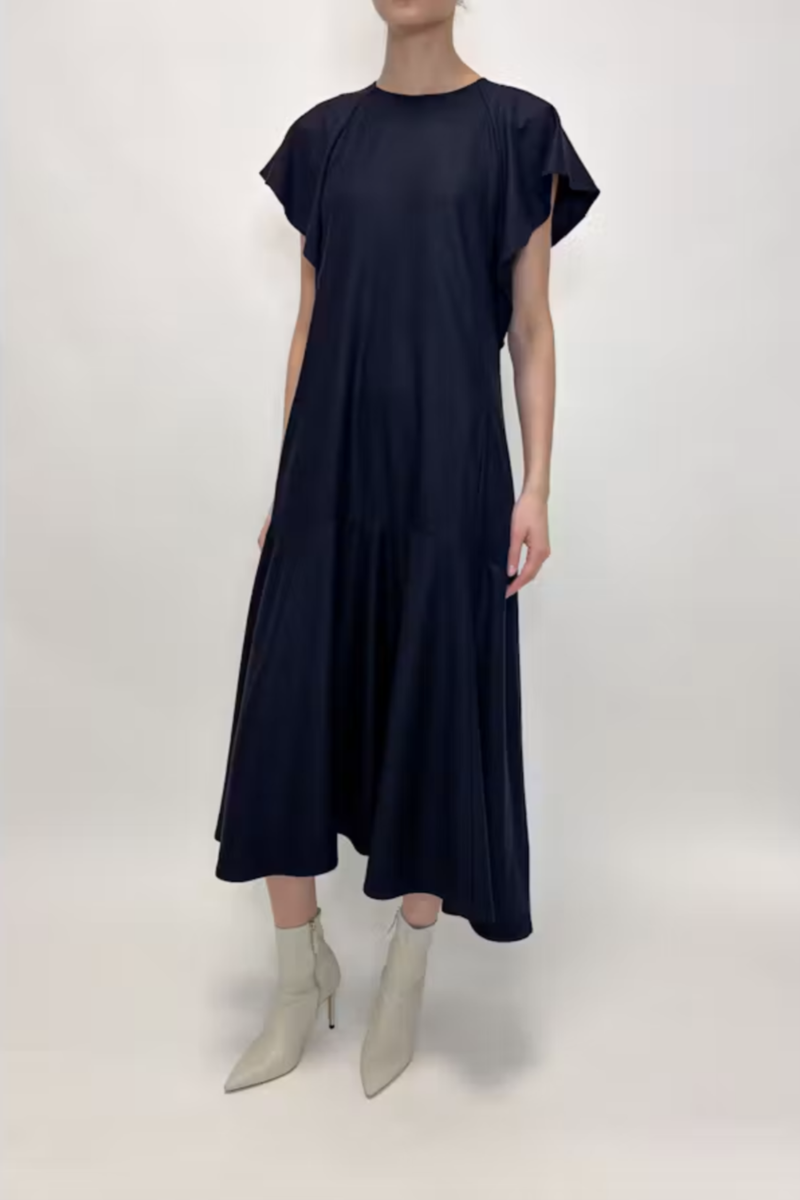 front profile model wearing Wool Jersey Dress navy 100% Wool Jersey
Flutter short sleeves
Midi Length
Crewneck
Front Pockets