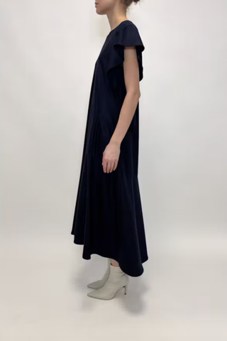 side profile model wearing Wool Jersey Dress navy 100% Wool Jersey
Flutter short sleeves
Midi Length
Crewneck
Front Pockets