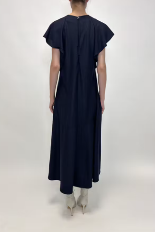 back profile model wearing Wool Jersey Dress navy 100% Wool Jersey
Flutter short sleeves
Midi Length
Crewneck
Front Pockets
