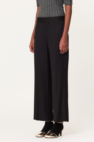 side profile model wearing Wool Trouser black Classic tailored
Straight-leg
Mid-to-high waistband
Belt loops
Extended asymmetric front button fastening
Side slip pockets
Crisp central front crease.
97% Virgin Wool 3% Elastam | LINING: 62% Cupro 38% Cotton