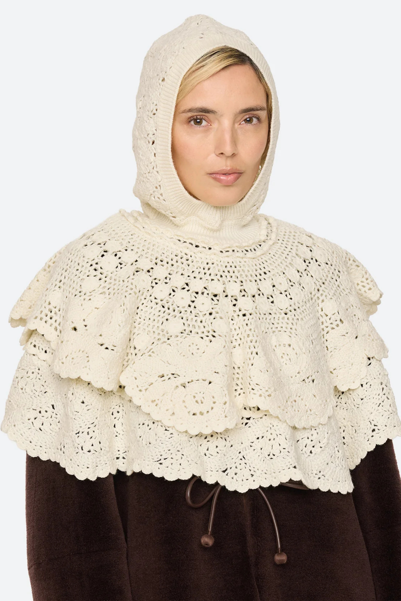 front profile model wearing with hood on Wright Poncho cream Knit poncho
Hand crocheted
Tiered layers of intricate crochet
Create a dimensional, textural silhouette
Finished with a hood
100% wool

Slip on
Relaxed fit