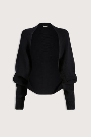 flat lay Yara Cotton Knit Shrug black Cropped shrug cardigan
Cotton knit
Open front with no closure
Ribbed detailing along the hem and cuffs
Relaxed, voluminous fit
Dropped seamless shoulders
Full sleeves
