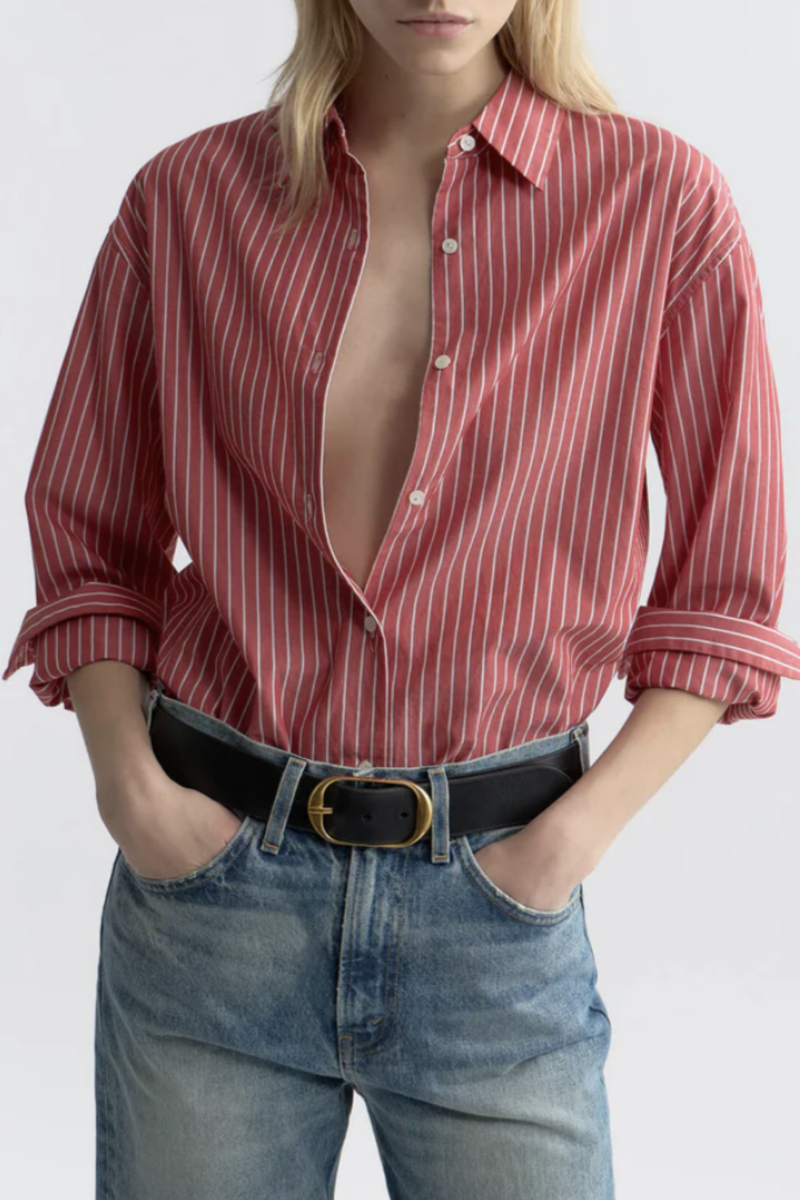 front profile model wearing Yorke Shirt In Stripe red white stripe Oversized button down
Italian cotton poplin
Buttoned center front placket
Sleeve cuff
Exaggerated shirt-tail hem &amp; body length
Garment-dyed