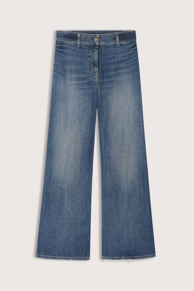 flat lay Megan Jean Classic Wash mid blue Mid-rise
Wide leg jean cotton
Japanese stretch denim
Fitted through waist and hips
Cropped ankle length
Opens to a relaxed leg
No front pockets
No outer side seam
Back patch pockets
Back darts
Zip fly