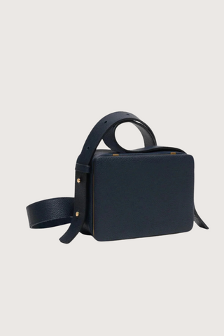 side profile of Maya Brandon Navy Bag pebbled leather exterior back pocket adjustable strap structured square shape with Stainless steel frame is 24k gold-plated