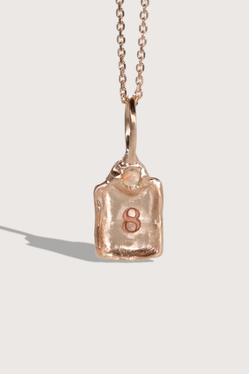 flat lay Lucky Number Charm Number 8 14k gold with rose cut diamond